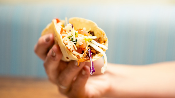 woman holding taco